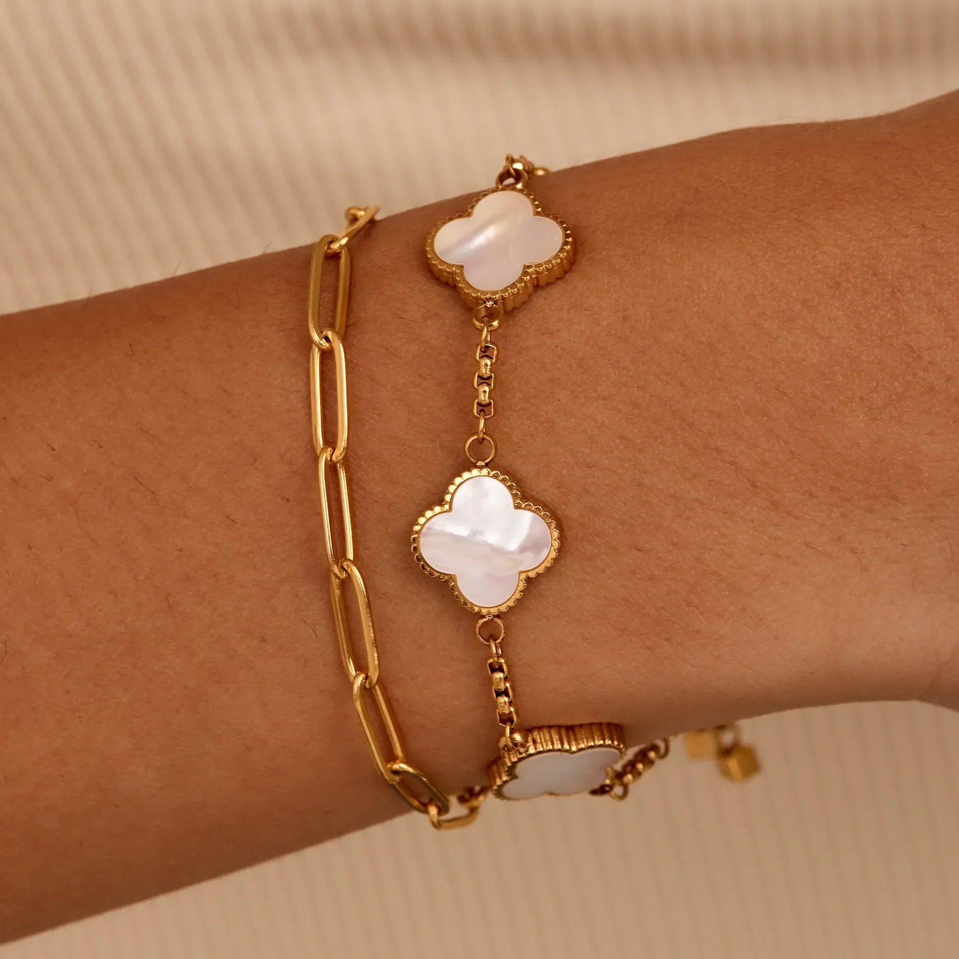 Gold pearl clover bracelet worn on wrist — Olivia Jewelry