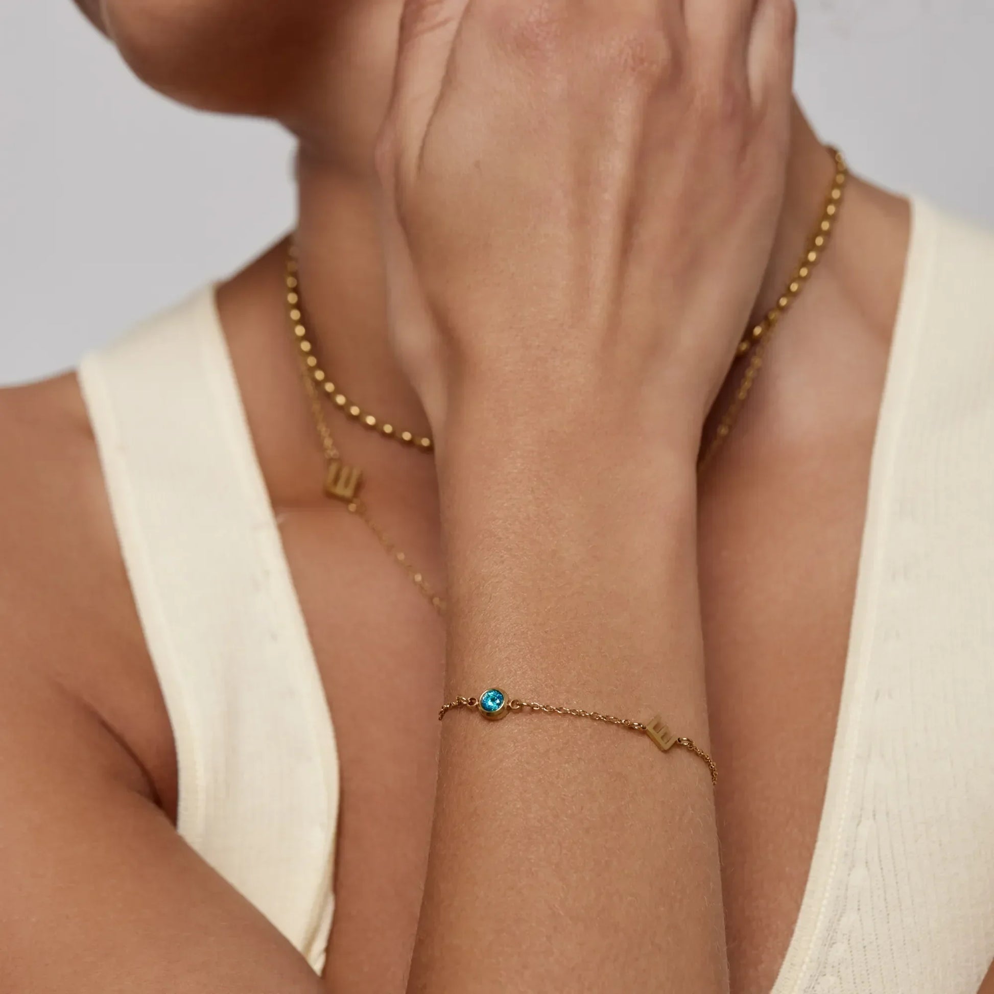 Initial birthstone bracelet lifestyle shot — Olivia Jewelry
