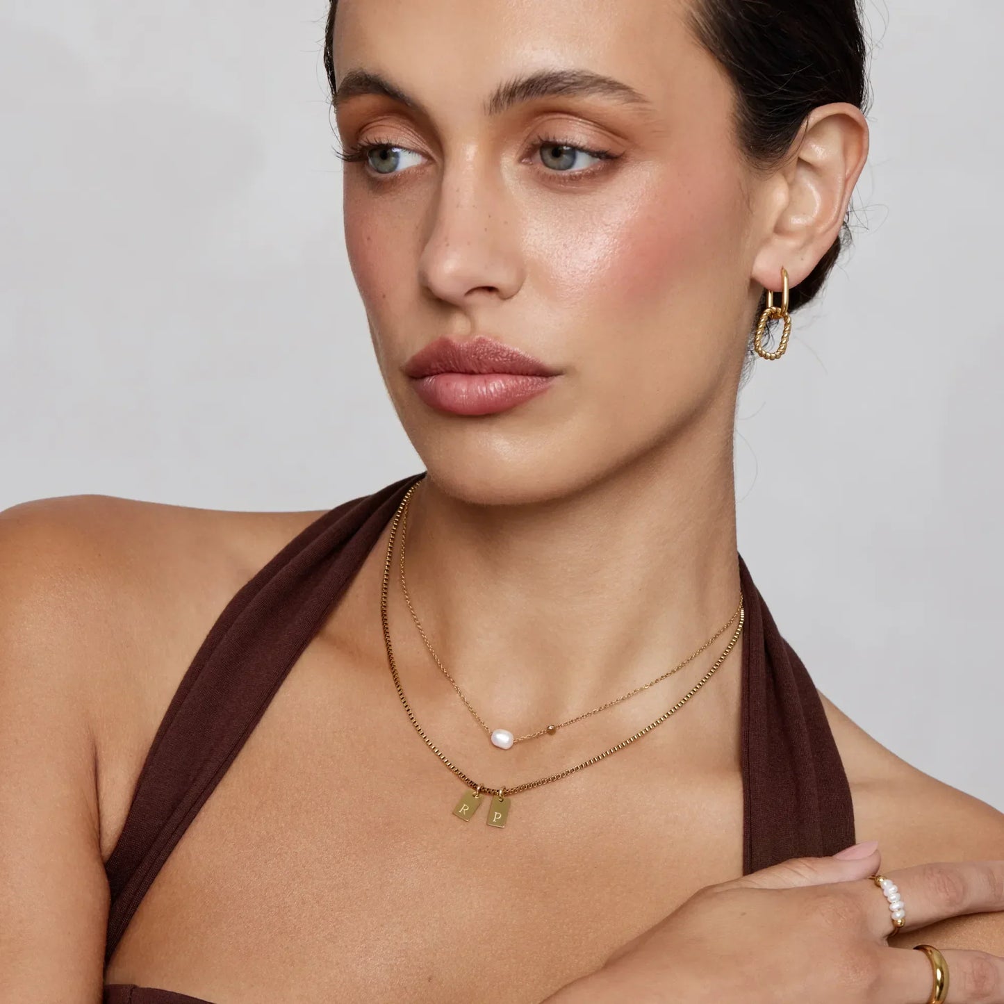 Gold initial tag necklace close-up detail — Olivia Jewelry