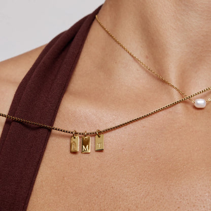 Custom initial tag necklace layered gold styling — Olivia Jewelry