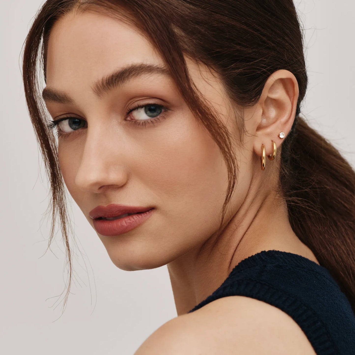 Gold tennis studs close-up detail — Olivia Jewelry