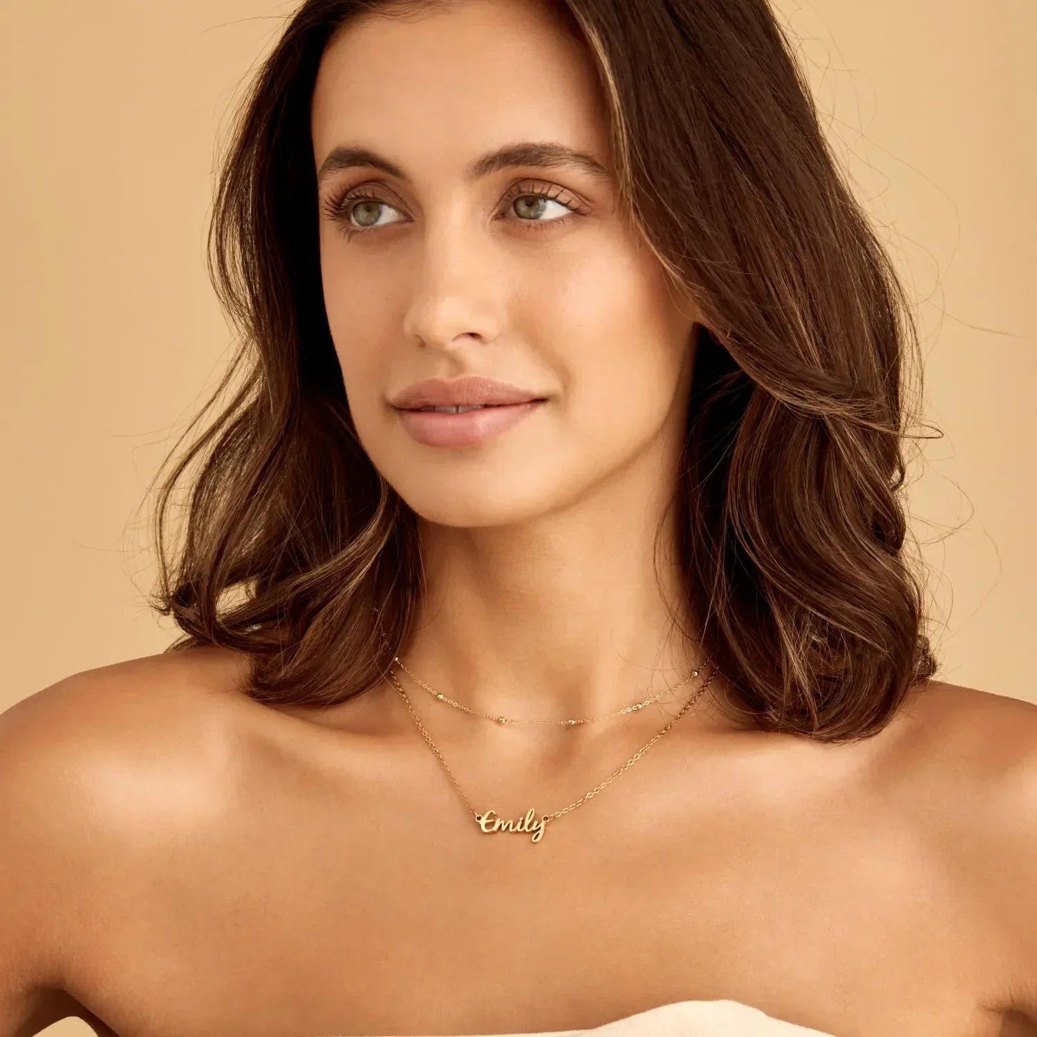 Gold signature name necklace worn on model — Olivia Jewelry