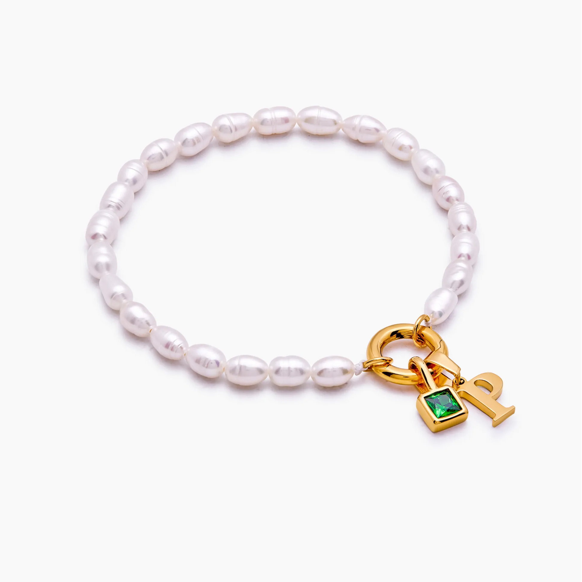 Pearl initial birthstone bracelet flat lay — Olivia Jewelry