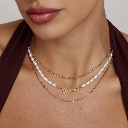 Statement name pearl necklace flat lay — Olivia Jewelry